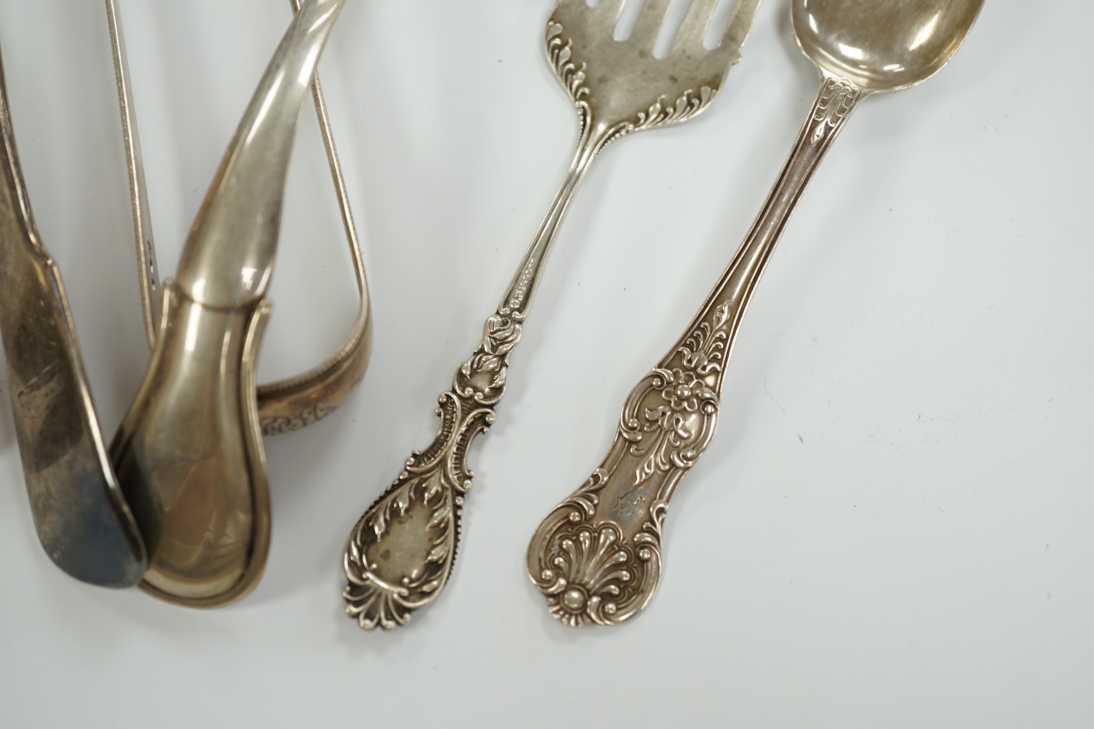 A Victorian silver fiddle pattern stilton scoop, London, 1847, 21.5cm and six other items of sundry flatware including Dutch white metal sifter spoon, smaller silver sifter spoons and a pair of Georgian silver sugar tong